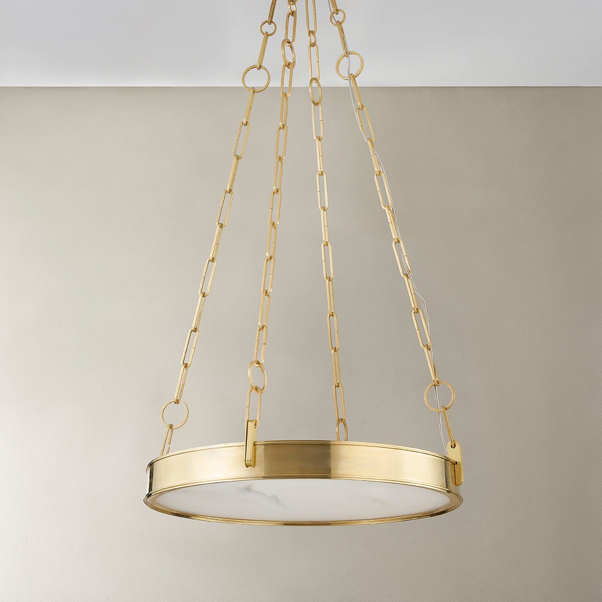 Close-up of the Kirby Chandelier 20" x 3.5" in aged brass showing the frame, arms, and shade detail.