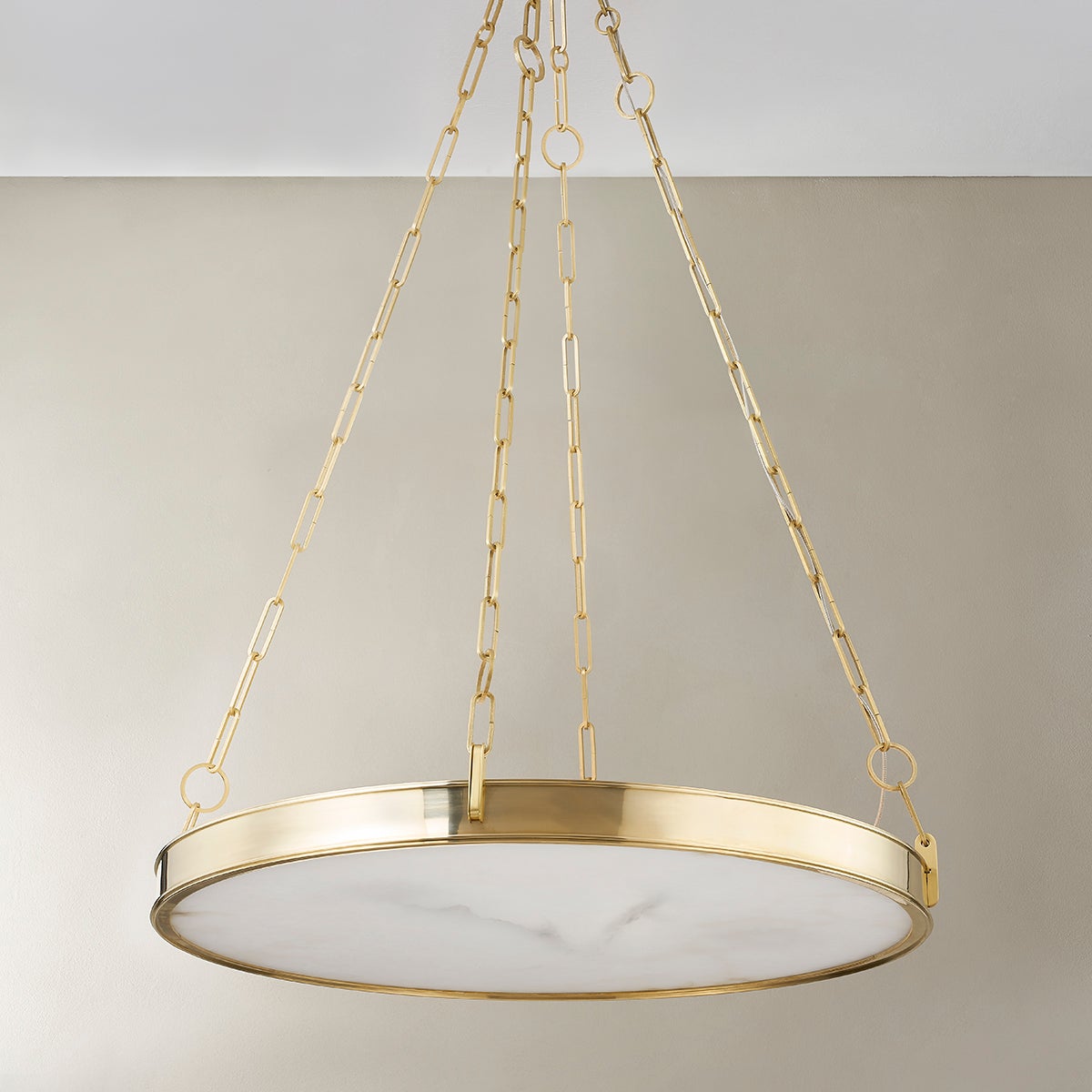 Close-up of the Kirby Chandelier 30" x 3.5" in aged brass showing the frame, arms, and shade detail.