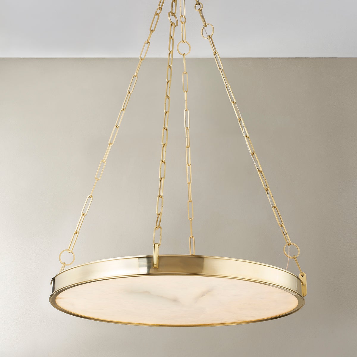 Close-up of the Kirby Chandelier 30" x 3.5" in aged brass showing the frame, arms, and shade detail.