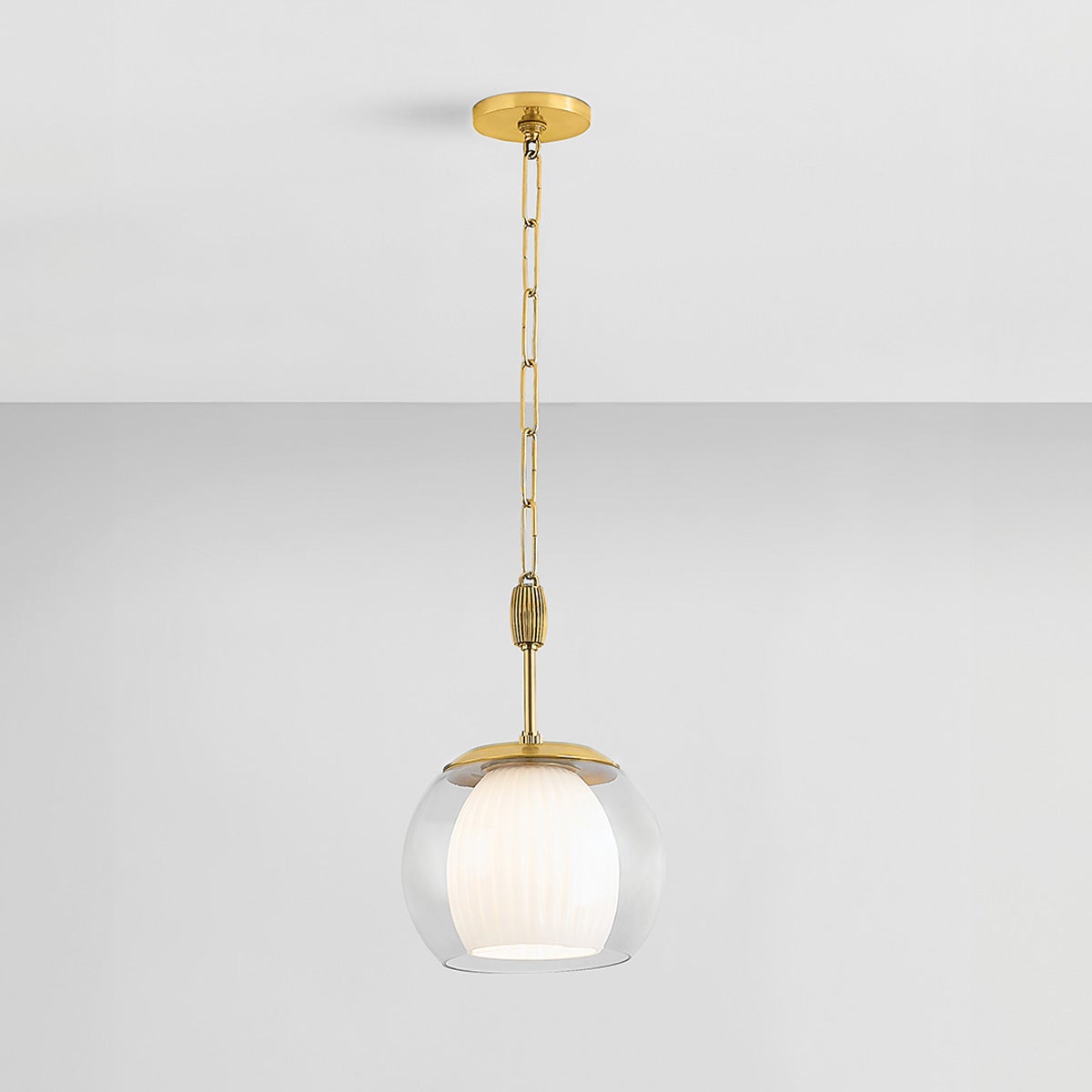 Close-up of the Clementon Pendant 11" in aged brass showing the shade shape and metal detail.