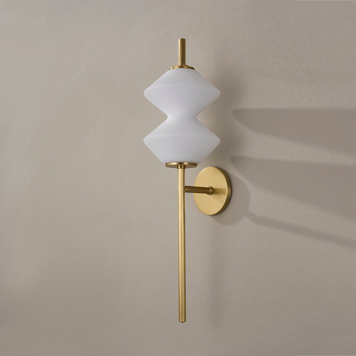 Barrow Wall Sconce in aged brass shown from a second angle to highlight the arm curve and shade silhouette.