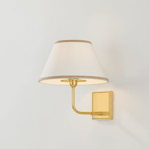 Durland Wall Sconce in aged brass shown from the front to reveal the arm curve and shade silhouette.
