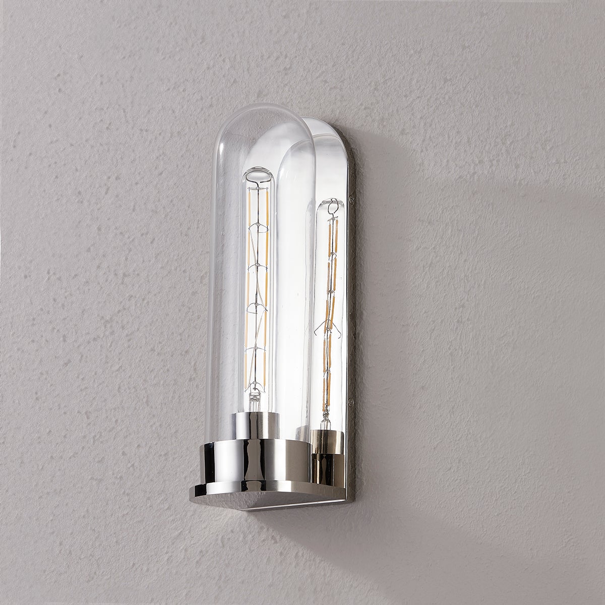 Close-up of the Irwin Wall Sconce in polished nickel showing the arm curve and shade silhouette.