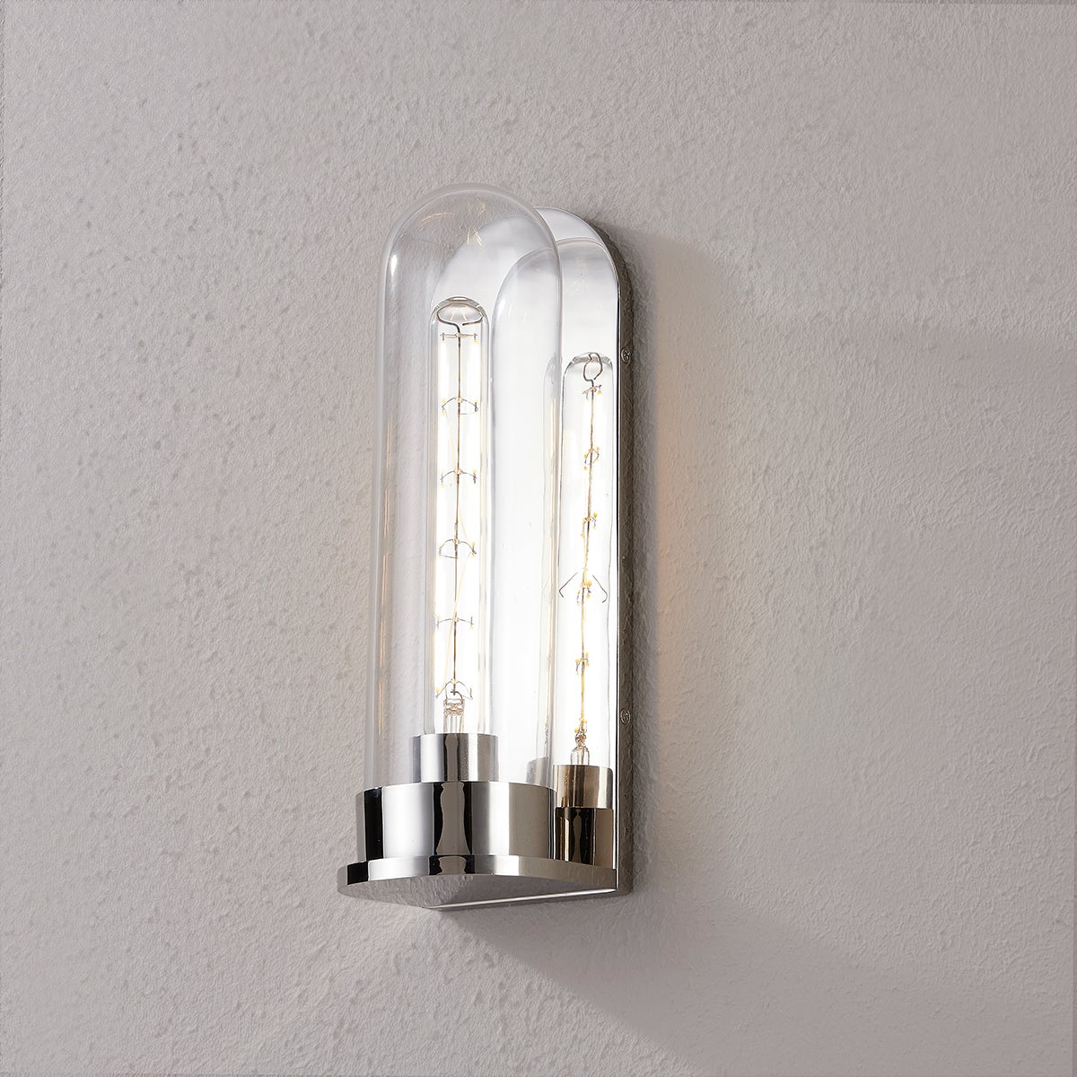 Close-up of the Irwin Wall Sconce in polished nickel showing the arm curve and shade silhouette.