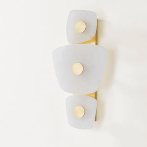 Holmdel Wall Sconce in aged brass shown from the front to reveal the arm curve and shade silhouette.