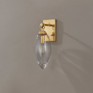 Close-up of the Nantucket Wall Sconce in aged brass showing the arm curve and shade silhouette.