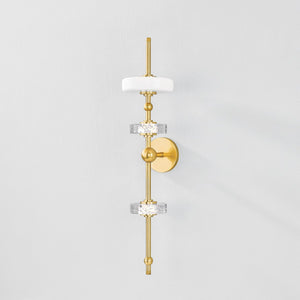 Maynard Wall Sconce in aged brass shown from the front to reveal the arm curve and shade silhouette.