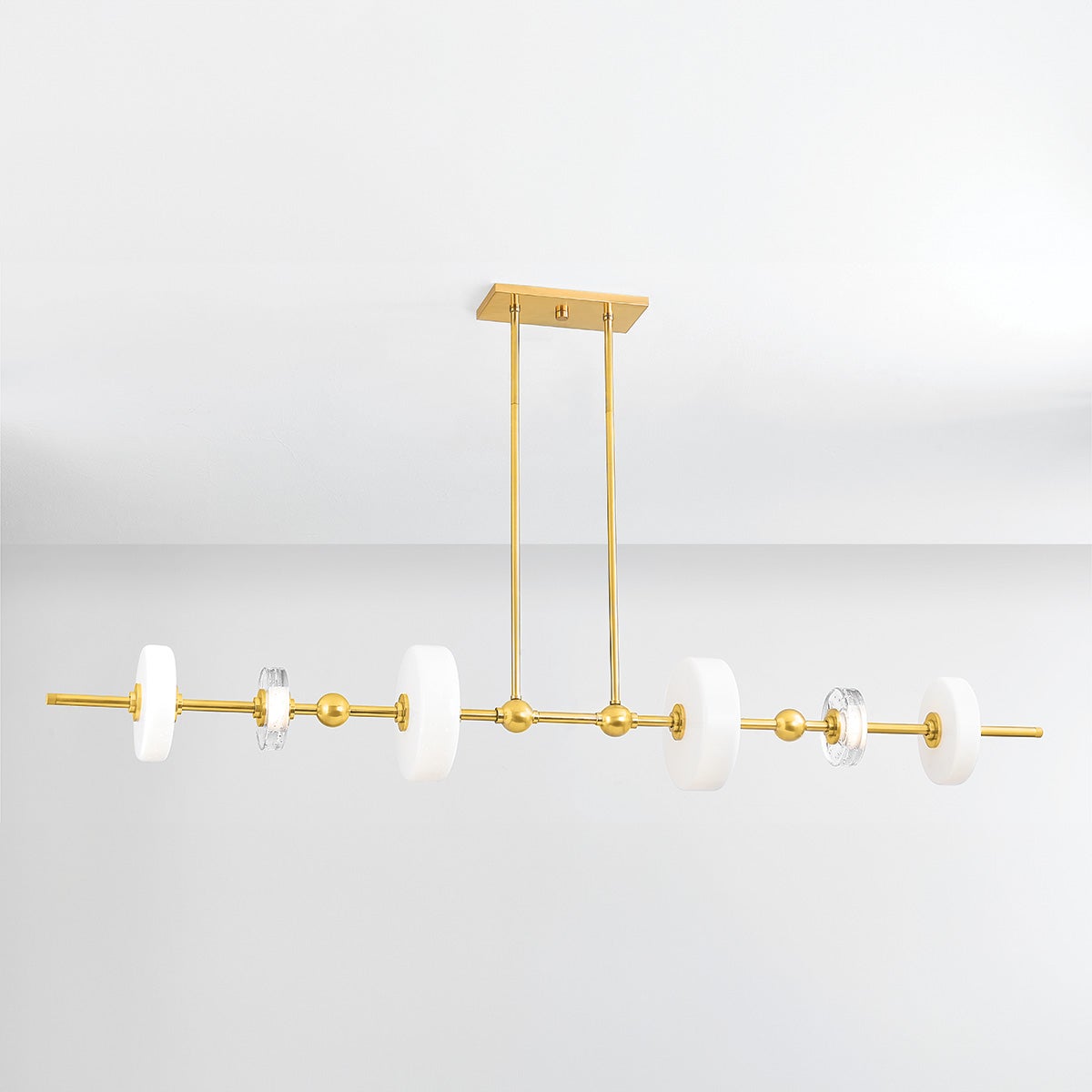 Close-up of the Maynard Linear in aged brass showing the extended frame and shade array.
