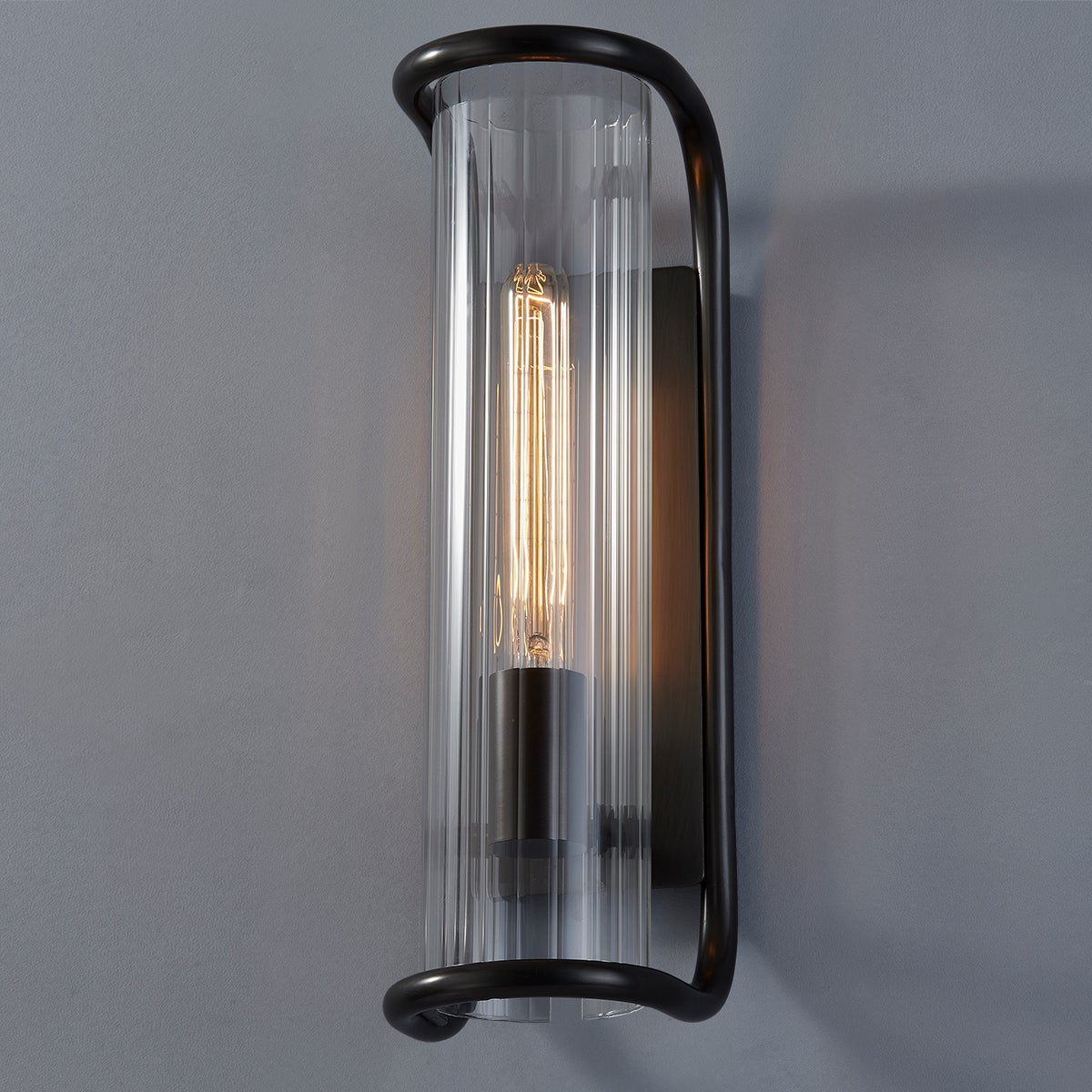 Fillmore Wall Sconce 5.5" x 16.75" in bronze shown from the front to reveal the arm curve and shade silhouette.