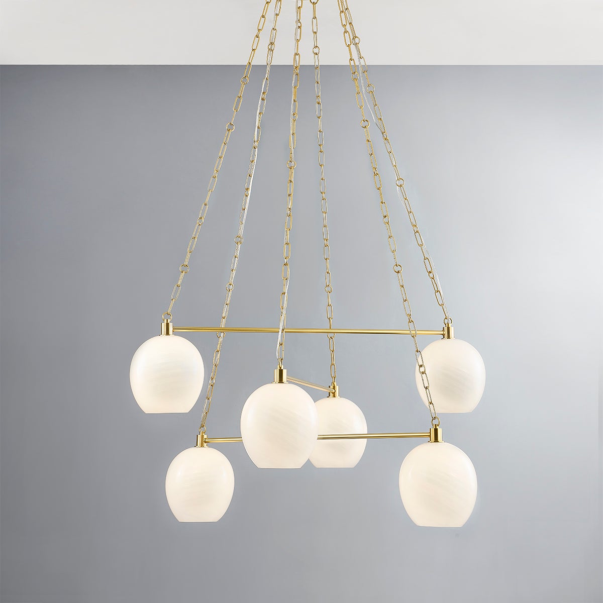 Close-up of the Asbury Park Chandelier 38" in aged brass showing the frame, arms, and shade detail.