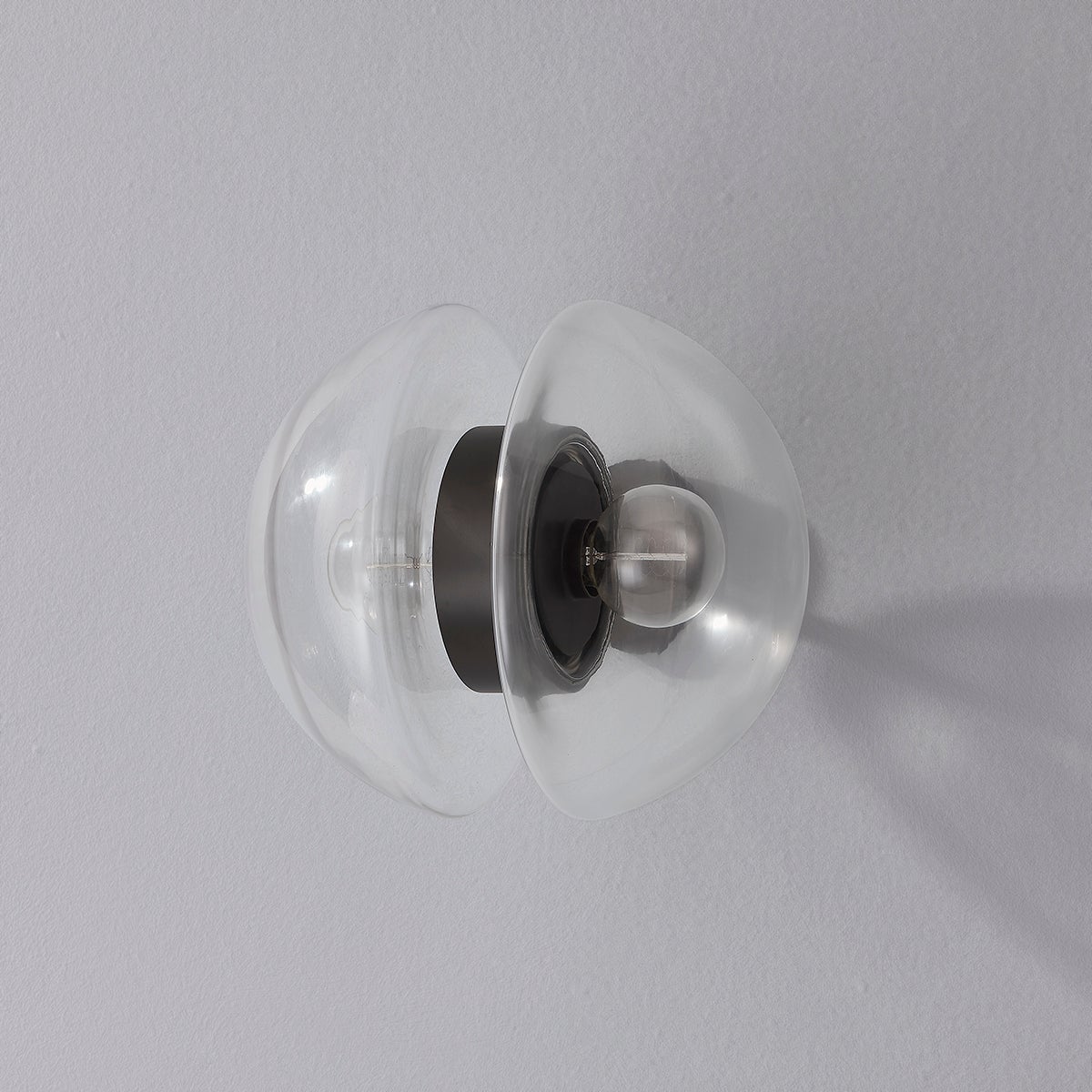 Close-up of the Kert Wall Sconce showing the arm curve and shade silhouette.