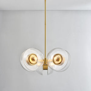 Close-up of the Kert Chandelier 27" in aged brass showing the frame, arms, and shade detail.
