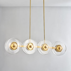Close-up of the Kert Linear in aged brass showing the extended frame and shade array.