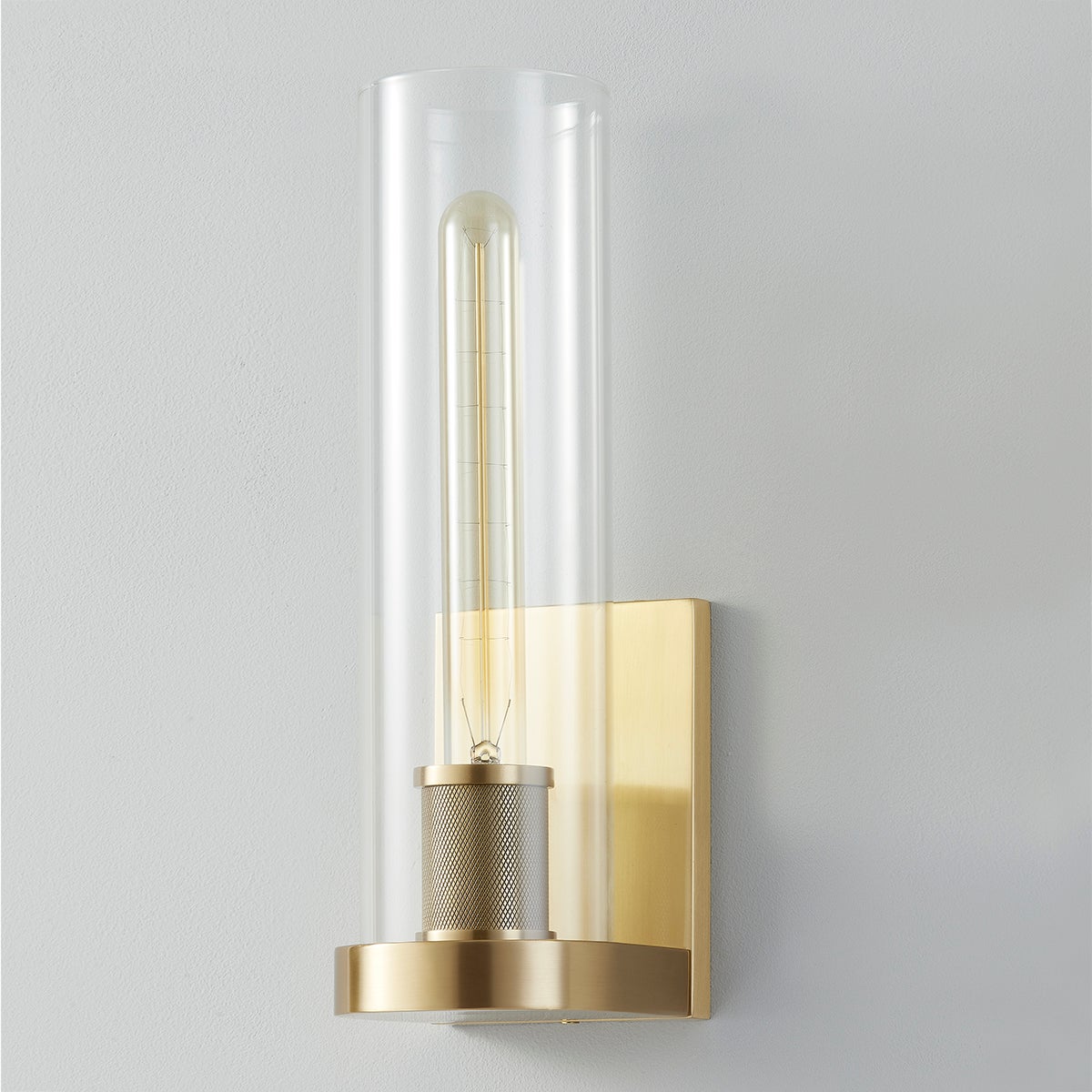 Porter Wall Sconce in aged brass shown from the front to reveal the arm curve and shade silhouette.