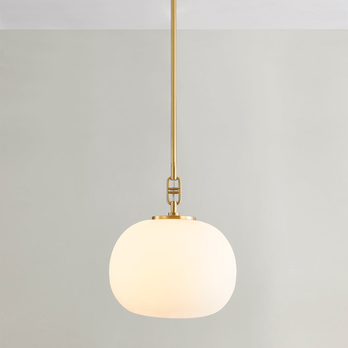 Ingels Pendant 11" in aged brass shown from the front to reveal the shade shape and metal detail.