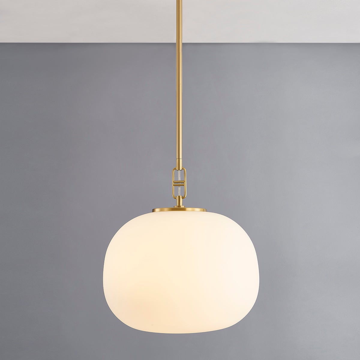 Ingels Pendant 16" in aged brass shown from the front to reveal the shade shape and metal detail.