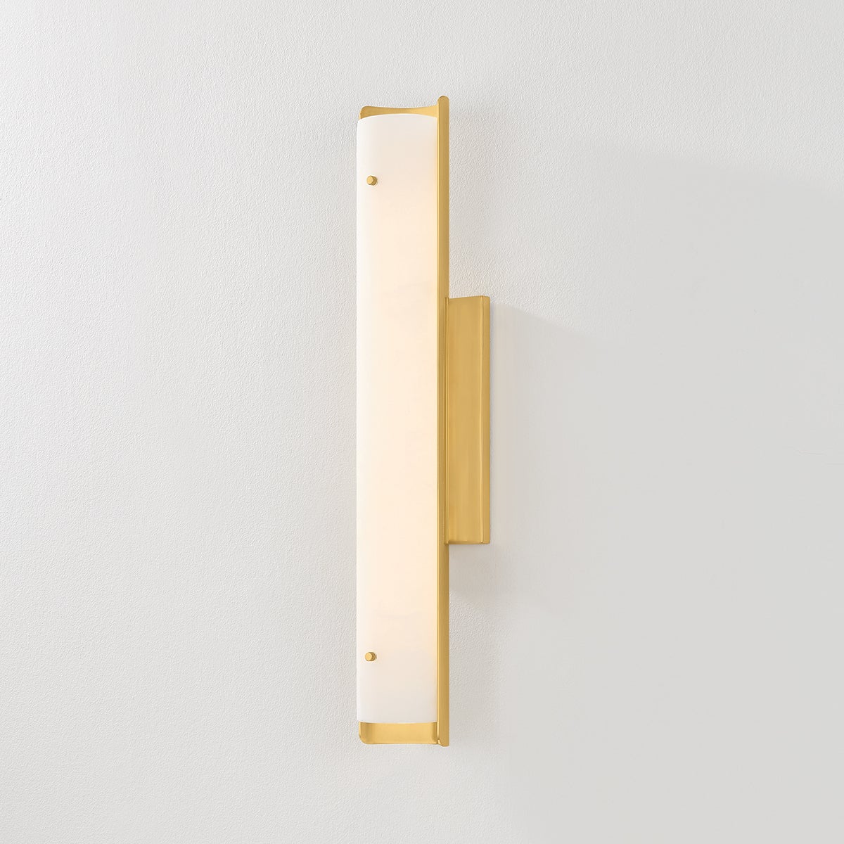 Close-up of the Lucio Wall Sconce 4.25" x 22.5" in aged brass showing the arm curve and shade silhouette.