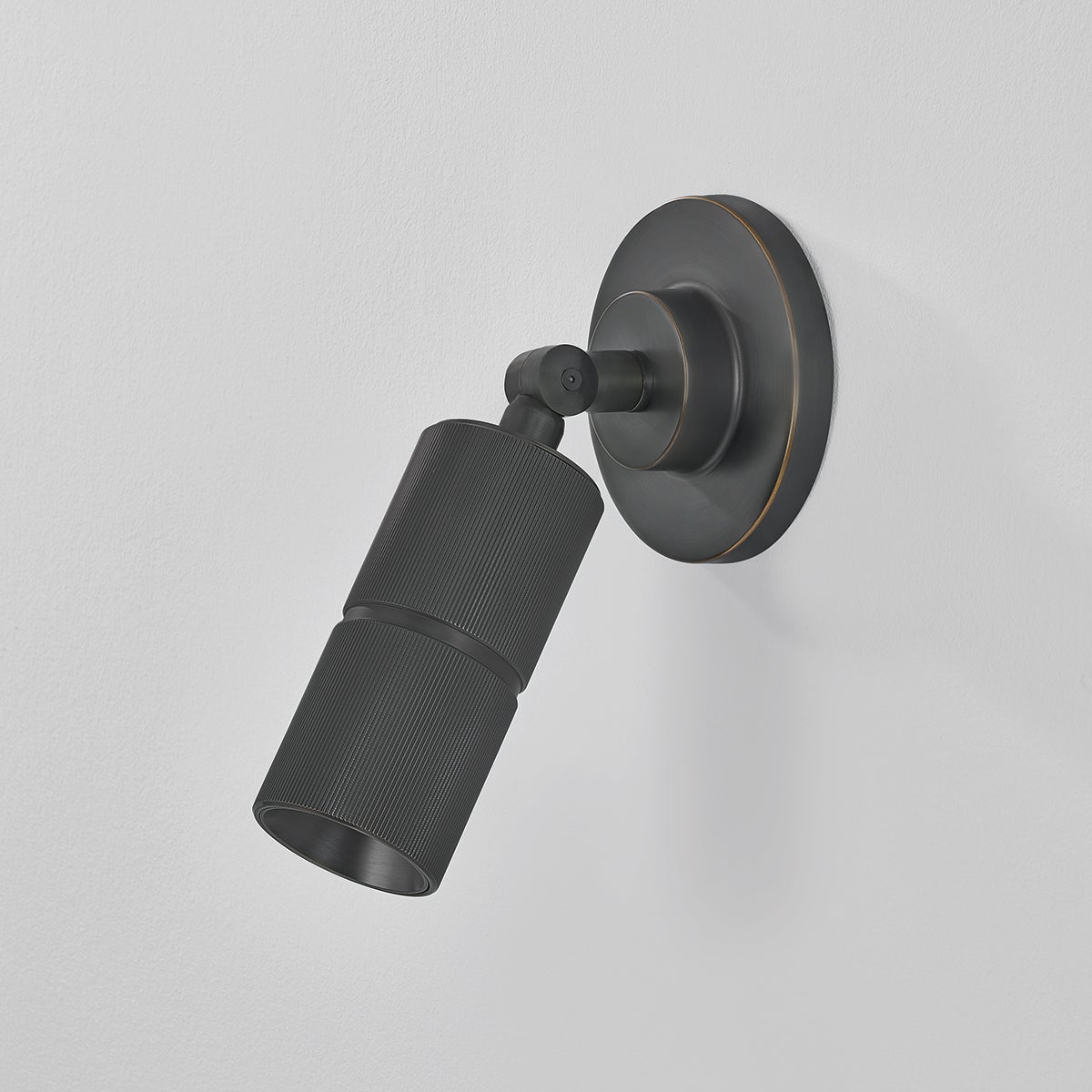 Close-up of the Truett Wall Sconce in dark bronze showing the arm curve and shade silhouette.