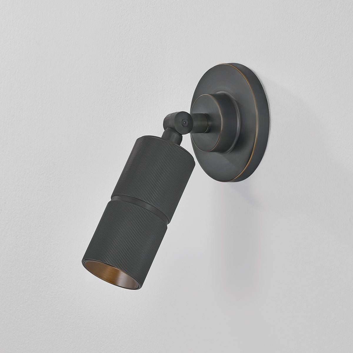 Close-up of the Truett Wall Sconce in dark bronze showing the arm curve and shade silhouette.