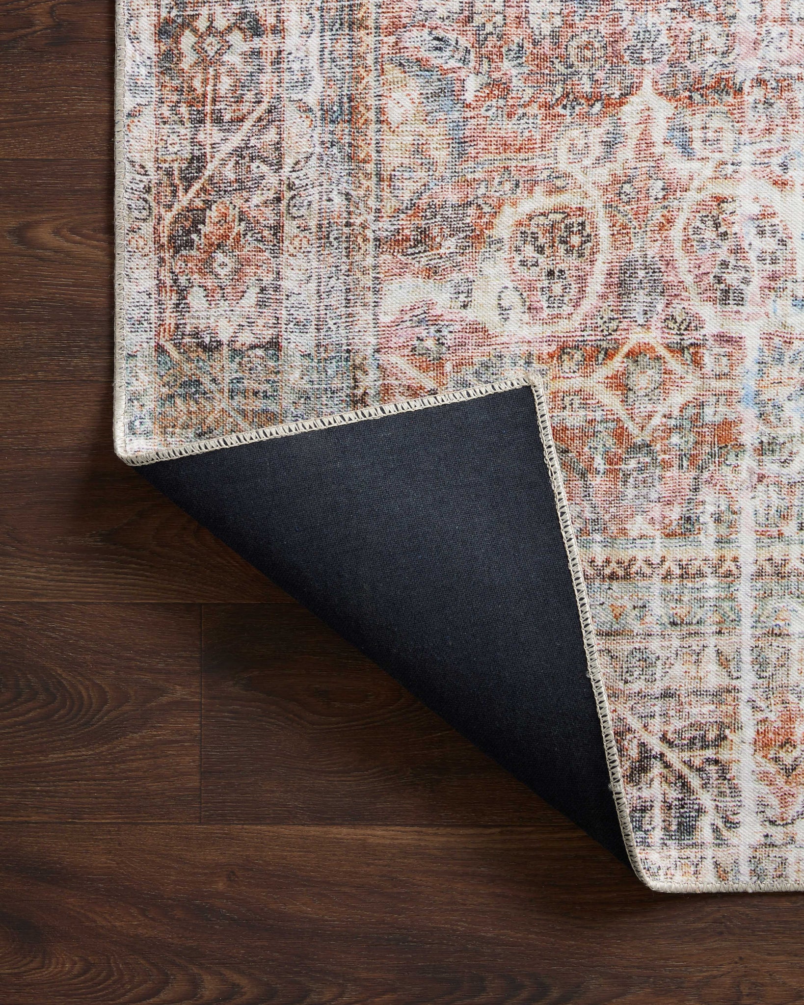 Adrian Sunset / Charcoal styled underfoot in a layered living room at Laurie Yapp Home.