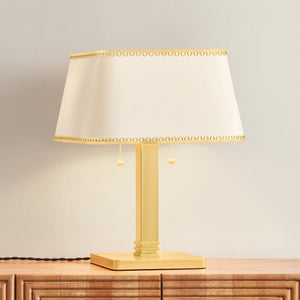 Claude Table Lamp in aged brass shown from the front to reveal the base and shade proportions.