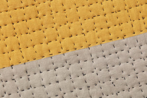 Proof Read Gold / Grey Rug Art shown from a different angle to reveal its pattern.