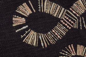 Snake Eyes Black / Beige Rug Art shown from a different angle to reveal its pattern.