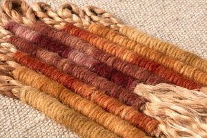 Chrissy Beige / Orange Rug Art shown from a different angle to reveal its pattern.