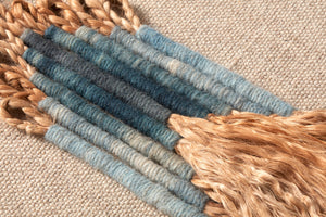 Ashley Beige / Blue Rug Art shown from a different angle to reveal its pattern.