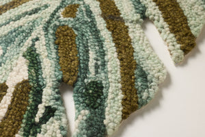Macadamia Green / Brown Rug Art shown from a different angle to reveal its pattern.