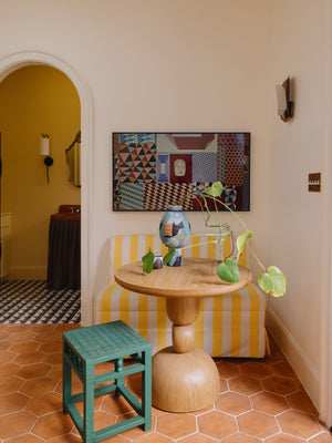 Adler Wall Sconce styled in a warmly lit hallway for warm, layered light at Laurie Yapp Home.