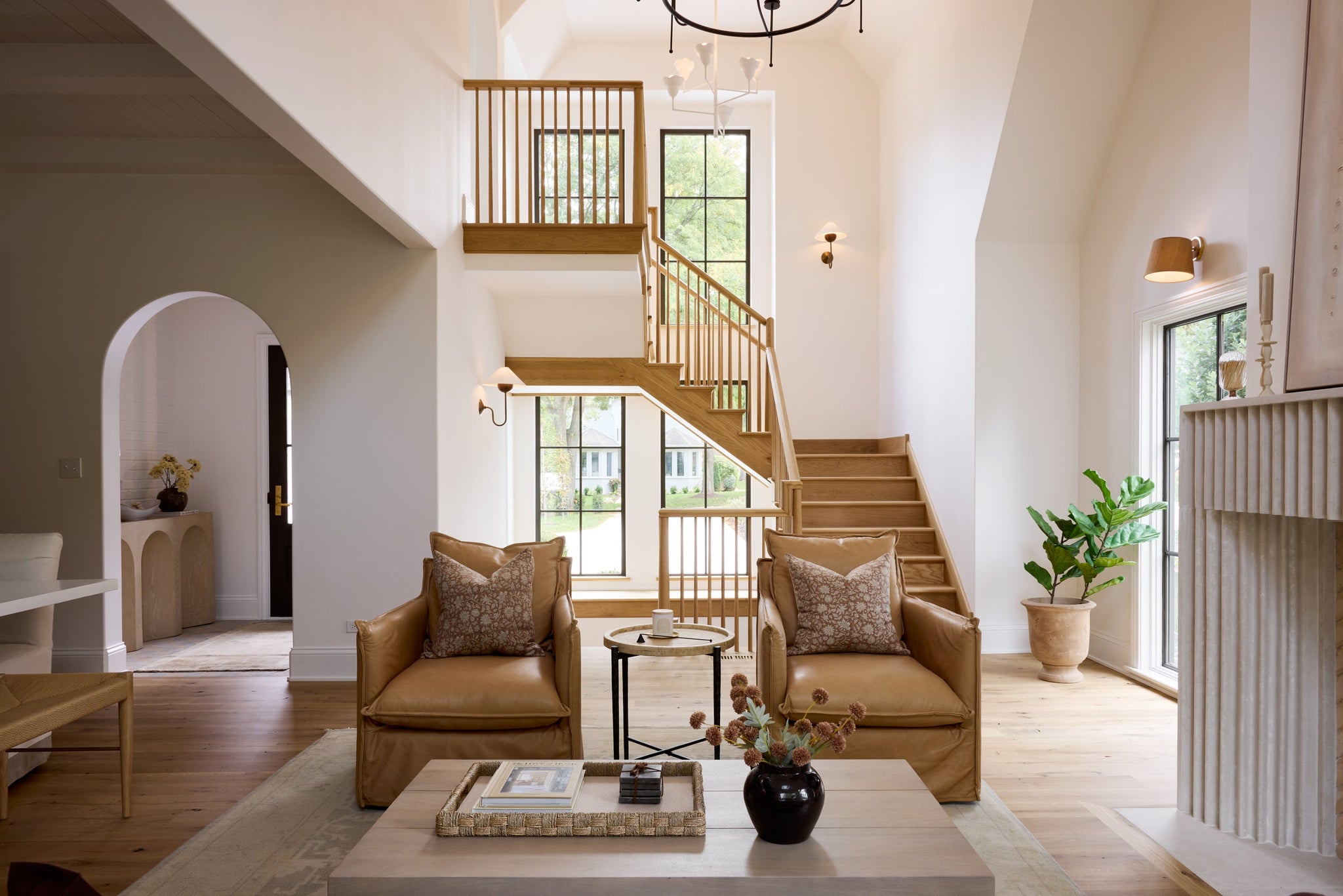 Alora Chandelier 32" in aged brass styled in an elegant dining room for warm, layered light at Laurie Yapp Home.
