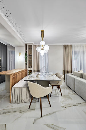 Hinsdale Linear in aged brass styled in a kitchen island for warm, layered light at Laurie Yapp Home.