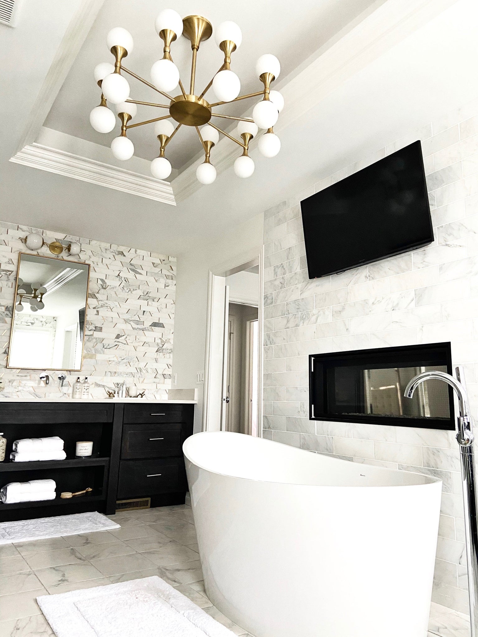 Astoria Chandelier 36" in aged brass styled in a two-story entry for warm, layered light at Laurie Yapp Home.