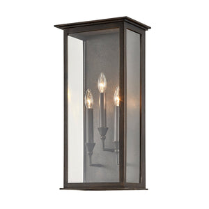 Chauncey Exterior Wall Sconce 11.5" x 23.5" styled in a warmly lit hallway for warm, layered light at Laurie Yapp Home.