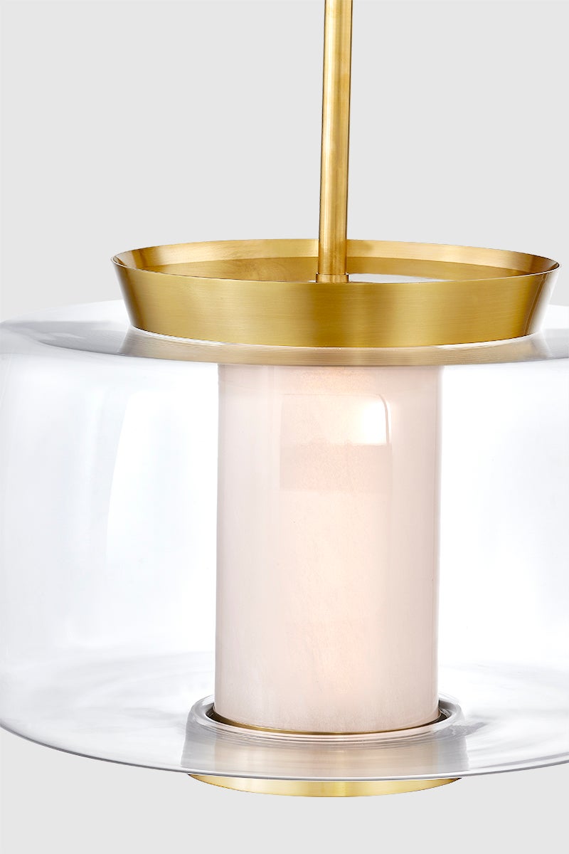 Close-up of the Beau Pendant 20" in aged brass showing the shade shape and metal detail.