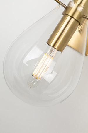 Close-up of the Ivy Wall Sconce in aged brass showing the arm curve and shade silhouette.