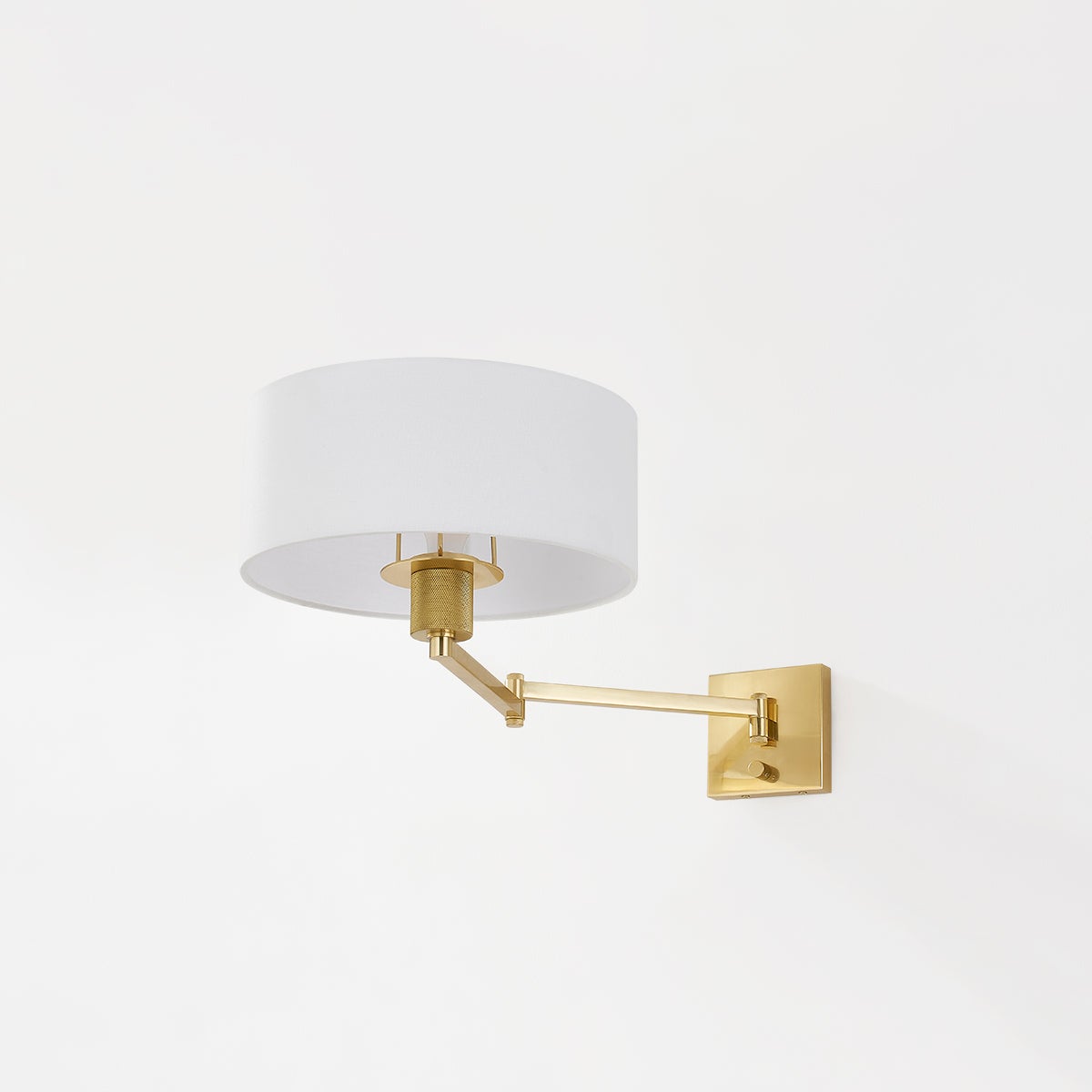 Close-up of the Sammy Wall Sconce in aged brass showing the arm curve and shade silhouette.