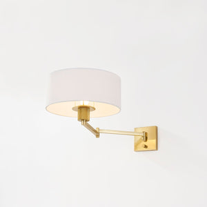 Close-up of the Sammy Wall Sconce in aged brass showing the arm curve and shade silhouette.