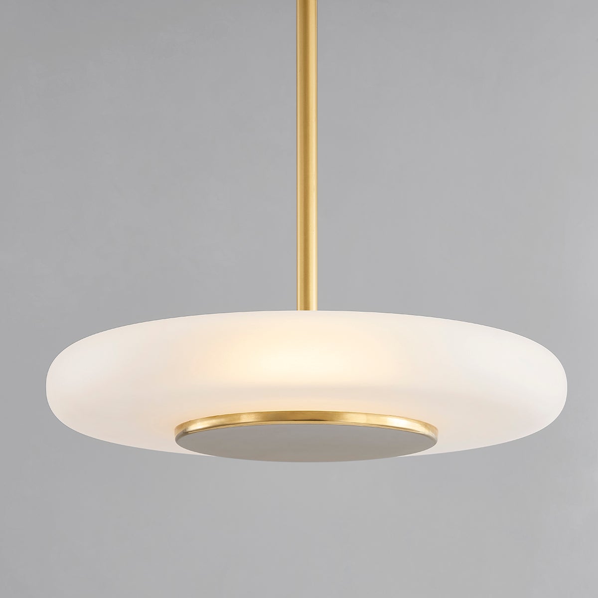 Blyford Pendant 20.75" in aged brass shown from the front to reveal the shade shape and metal detail.