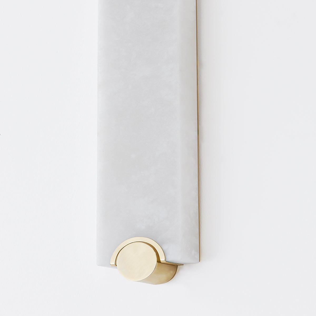 Brant Wall Sconce in aged brass shown from the front to reveal the arm curve and shade silhouette.