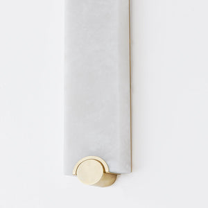 Brant Wall Sconce in aged brass shown from the front to reveal the arm curve and shade silhouette.