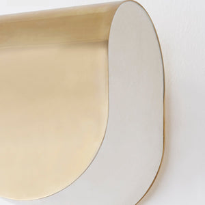 Close-up of the Briarwood Wall Sconce 6.5" in aged brass showing the arm curve and shade silhouette.