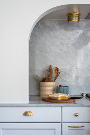 Bangor Flush Mount in aged brass styled in an entryway for warm, layered light at Laurie Yapp Home.