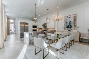 Bari Chandelier 30" in aged brass styled in a two-story entry for warm, layered light at Laurie Yapp Home.