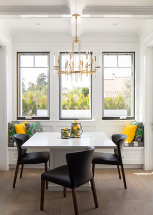 Bari Chandelier 30" in aged brass styled in an elegant dining room for warm, layered light at Laurie Yapp Home.