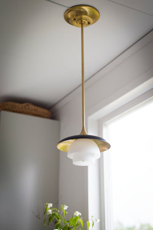 Barron pendant styled over a kitchen island for focused overhead lighting in an aged brass finish.
