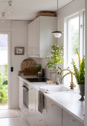 Barron pendant in a modern entryway, casting warm downlight from its aged brass shade.