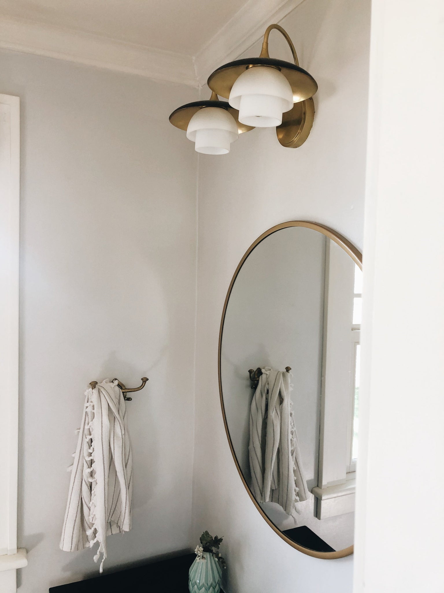 Barron Bath & Vanity in aged brass styled in a powder room for warm, layered light at Laurie Yapp Home.