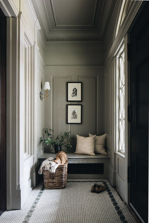 Barton Wall Sconce 7.5" in aged brass styled in a curated living room for warm, layered light at Laurie Yapp Home.